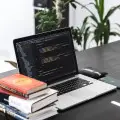 macbook pro on black wooden table